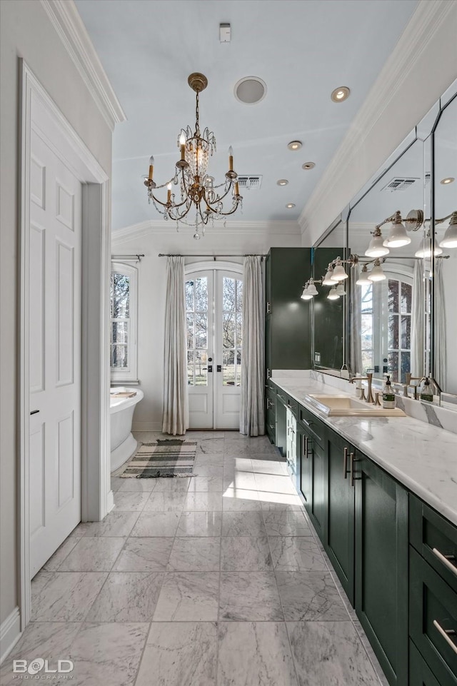 bathroom featuring vanity, a tub to relax in, crown molding, and french doors