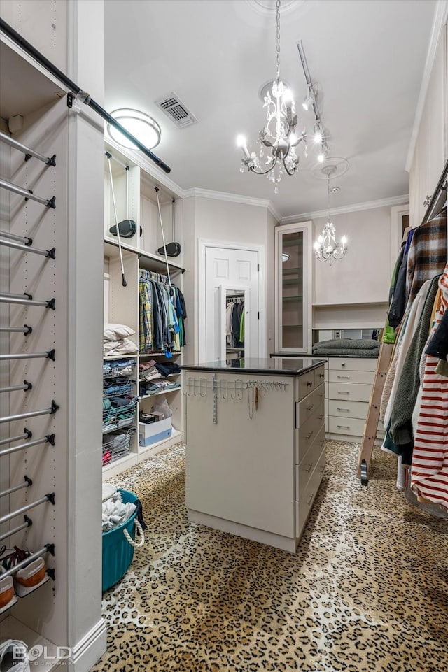 walk in closet with an inviting chandelier