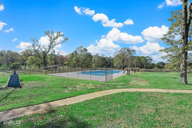 exterior space with a yard and tennis court