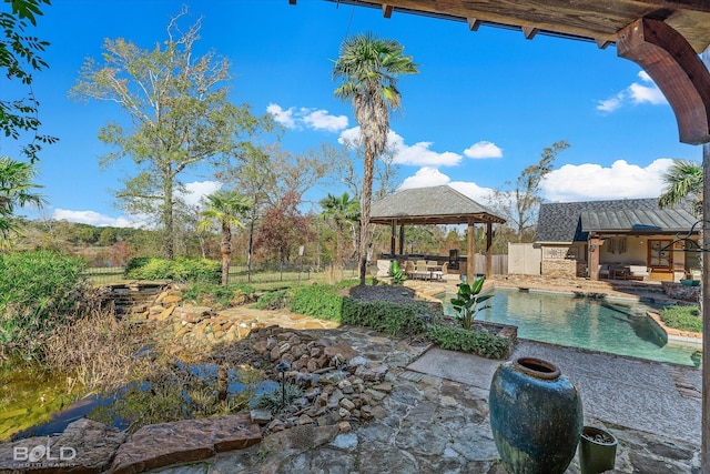 exterior space with a gazebo and a fenced in pool