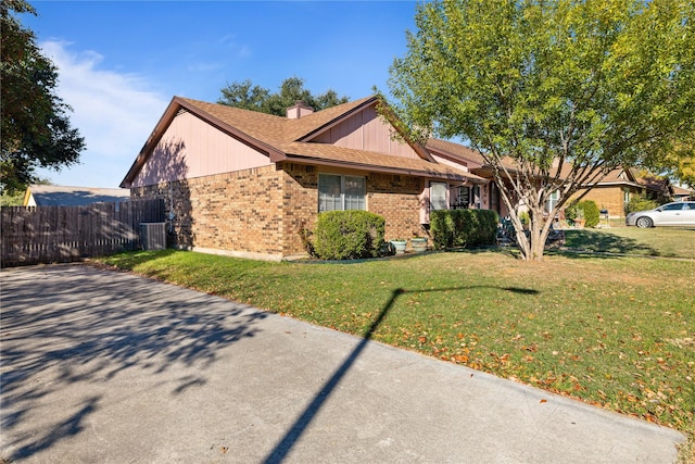 ranch-style house with a front yard and central air condition unit