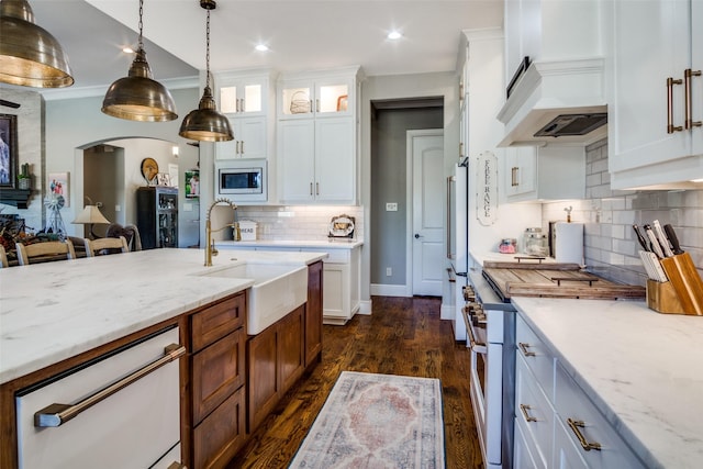 kitchen featuring sink, white cabinets, and white appliances