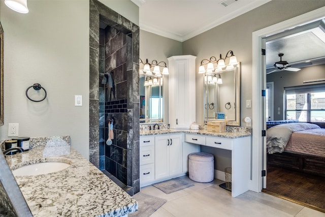 bathroom with hardwood / wood-style floors, vanity, ceiling fan, ornamental molding, and a tile shower