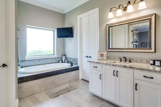 bathroom with tile patterned flooring, vanity, crown molding, and tiled tub