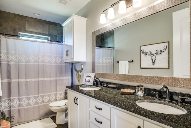 bathroom with a shower with shower curtain, vanity, and toilet