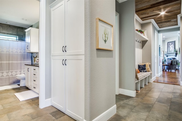 hall with crown molding, wooden ceiling, and light wood-type flooring