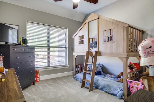 carpeted bedroom with ceiling fan and lofted ceiling