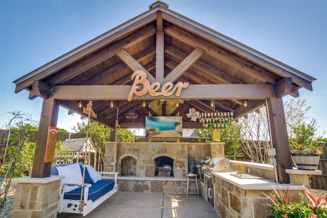 view of patio with a gazebo, an outdoor stone fireplace, area for grilling, and a grill