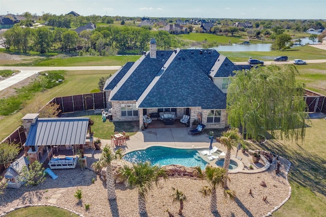 view of swimming pool with a patio area and a water view