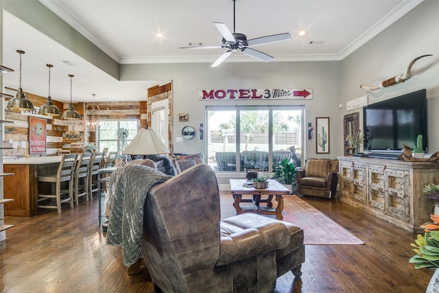 living room with dark hardwood / wood-style floors, ceiling fan, and ornamental molding