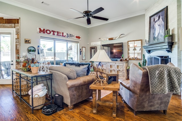 living room with dark hardwood / wood-style flooring, a wealth of natural light, and ornamental molding