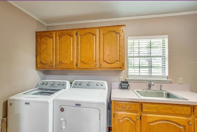 laundry area featuring washer and dryer, cabinets, sink, and crown molding