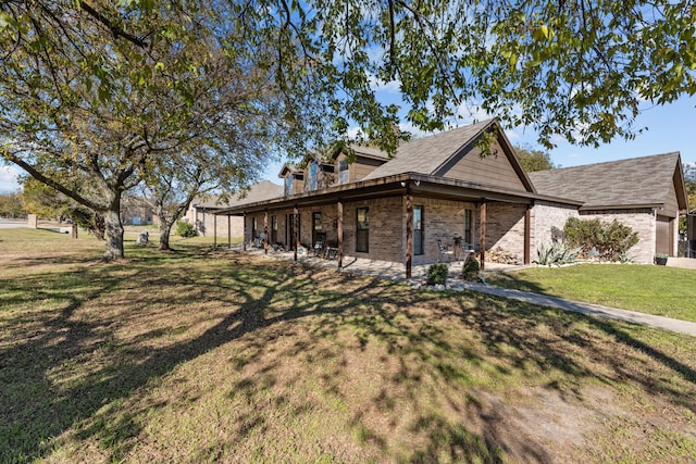 view of side of property featuring a yard and a patio