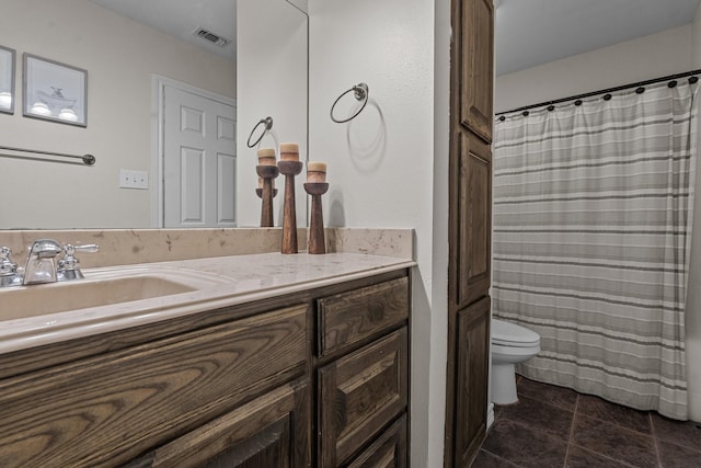 bathroom featuring tile patterned floors, vanity, and toilet