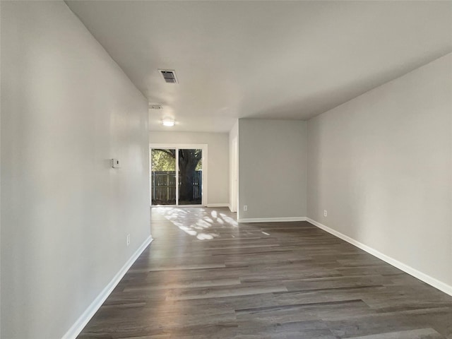 unfurnished room with dark hardwood / wood-style flooring