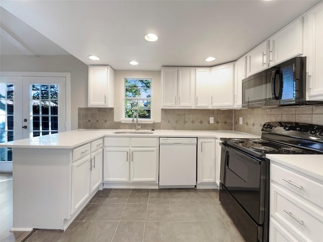 kitchen featuring kitchen peninsula, sink, white cabinetry, and black appliances