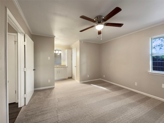 unfurnished bedroom with carpet, ceiling fan, ornamental molding, and ensuite bathroom