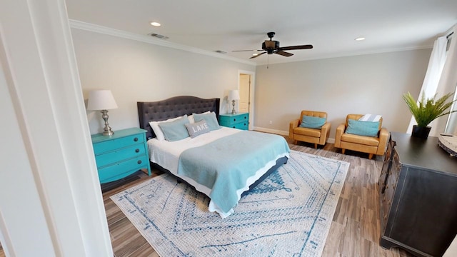 bedroom featuring wood-type flooring, ceiling fan, and ornamental molding