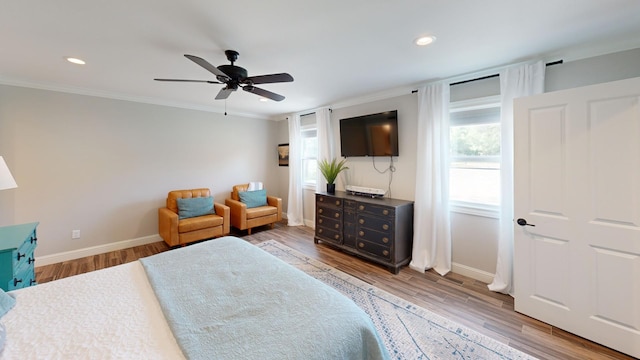 bedroom featuring wood-type flooring, ceiling fan, and ornamental molding