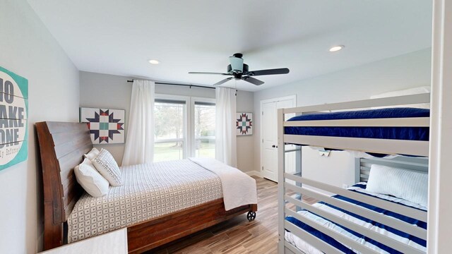 bedroom with ceiling fan and hardwood / wood-style floors