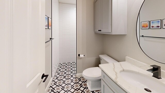 bathroom with tile patterned flooring, toilet, a shower, and vanity