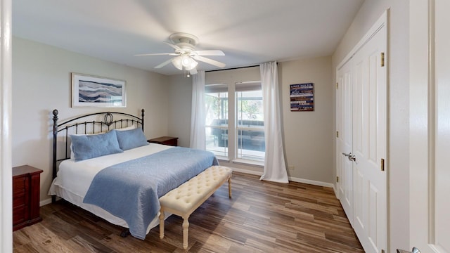 bedroom featuring a closet, dark hardwood / wood-style floors, and ceiling fan