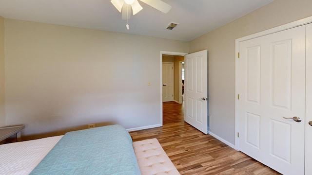 bedroom featuring light wood-type flooring, a closet, and ceiling fan