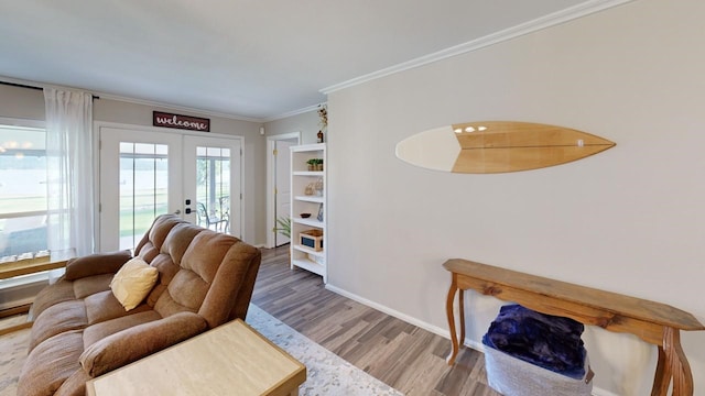 living room featuring wood-type flooring, french doors, and ornamental molding