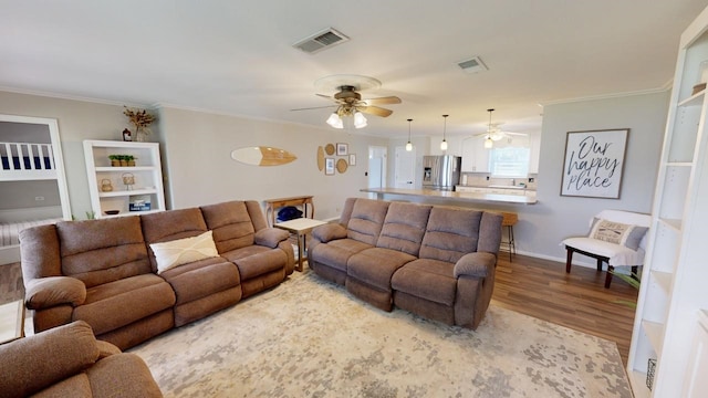 living room featuring hardwood / wood-style flooring and ornamental molding