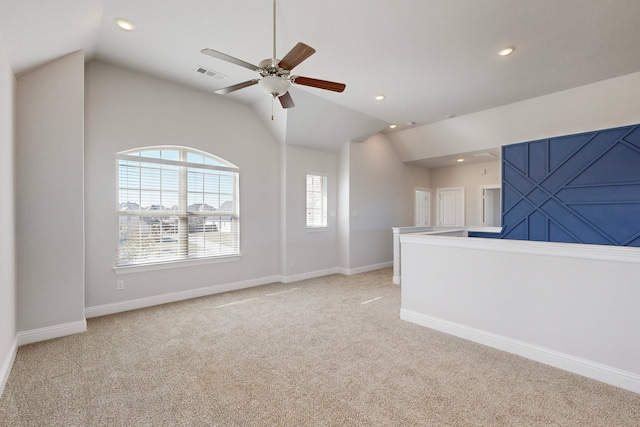 unfurnished living room featuring ceiling fan, light carpet, and vaulted ceiling