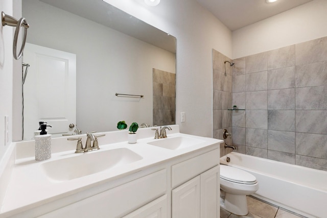 full bathroom featuring toilet, tile patterned flooring, vanity, and tiled shower / bath