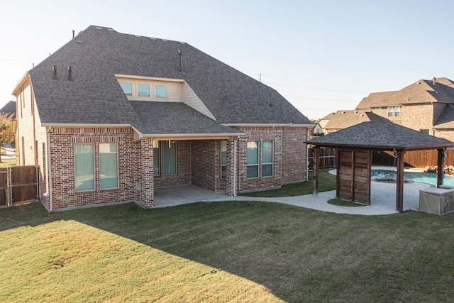 rear view of house featuring a yard and a patio