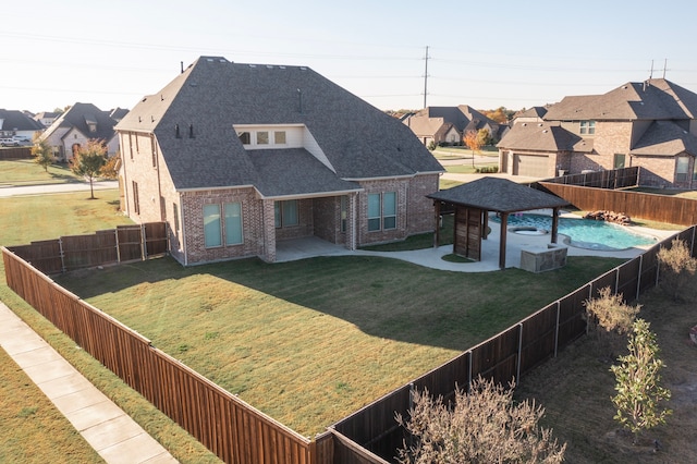 exterior space featuring a front yard, a gazebo, and a patio