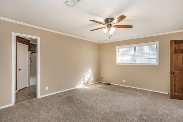 unfurnished bedroom with carpet flooring, a walk in closet, ceiling fan, and crown molding