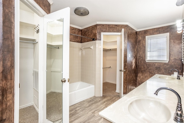 bathroom with vanity, hardwood / wood-style flooring, independent shower and bath, and crown molding