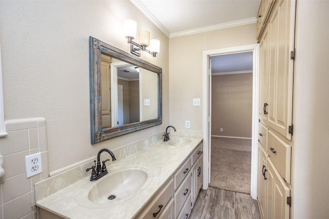 bathroom featuring wood-type flooring, vanity, and ornamental molding