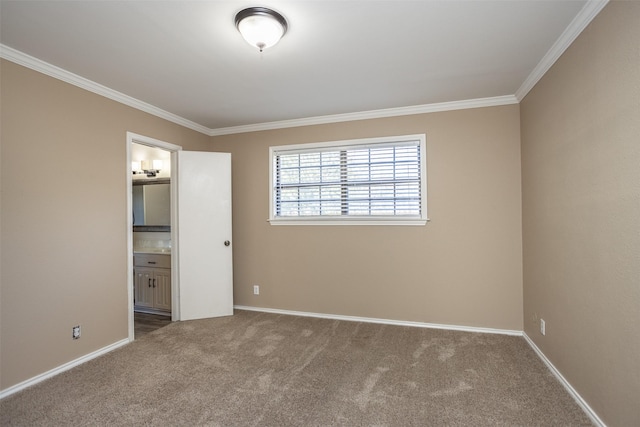 unfurnished bedroom featuring ensuite bathroom, crown molding, and carpet