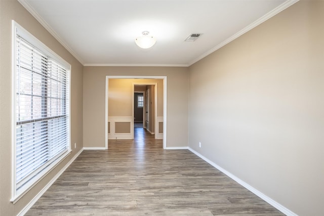 unfurnished room featuring crown molding and light hardwood / wood-style flooring