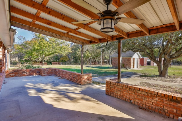 view of patio with ceiling fan and an outdoor structure