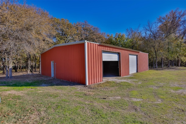 view of outbuilding with a yard and a garage