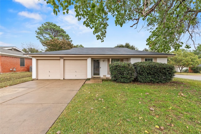 single story home with a front yard and a garage