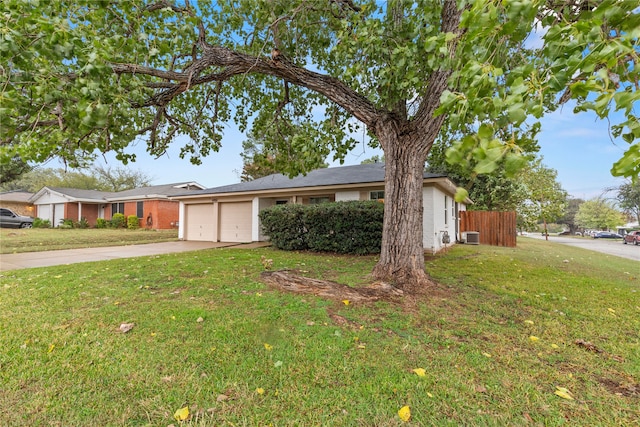 ranch-style house featuring a garage and a front lawn