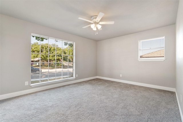 empty room with ceiling fan and carpet floors