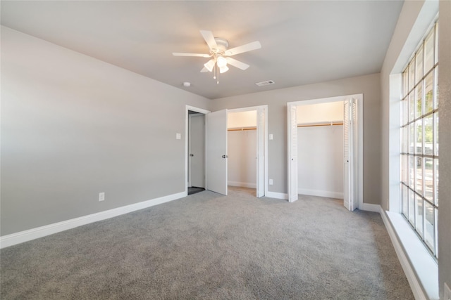 unfurnished bedroom with ceiling fan and light colored carpet