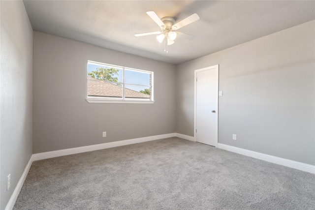 spare room with carpet and ceiling fan