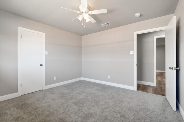 spare room featuring ceiling fan and carpet floors