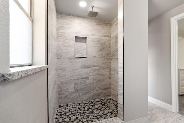 bathroom with a tile shower