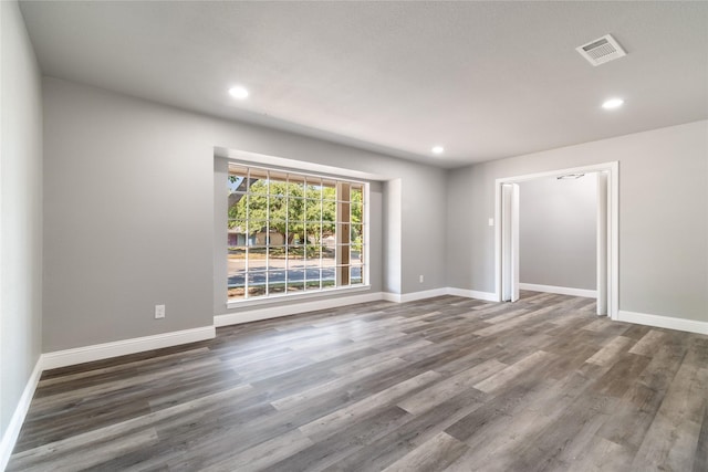 unfurnished room with dark hardwood / wood-style flooring