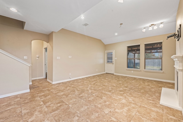 unfurnished living room with vaulted ceiling