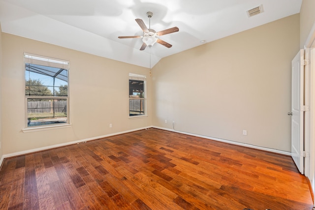 empty room with hardwood / wood-style flooring, vaulted ceiling, and ceiling fan